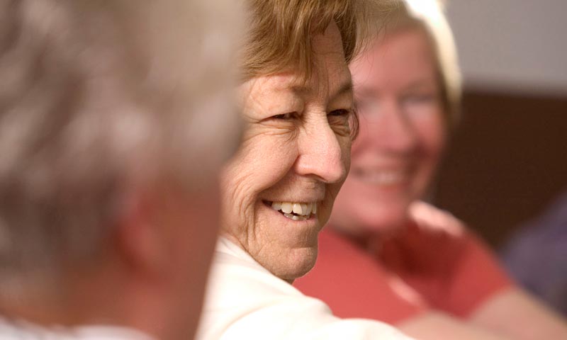 Older woman smiling with friends